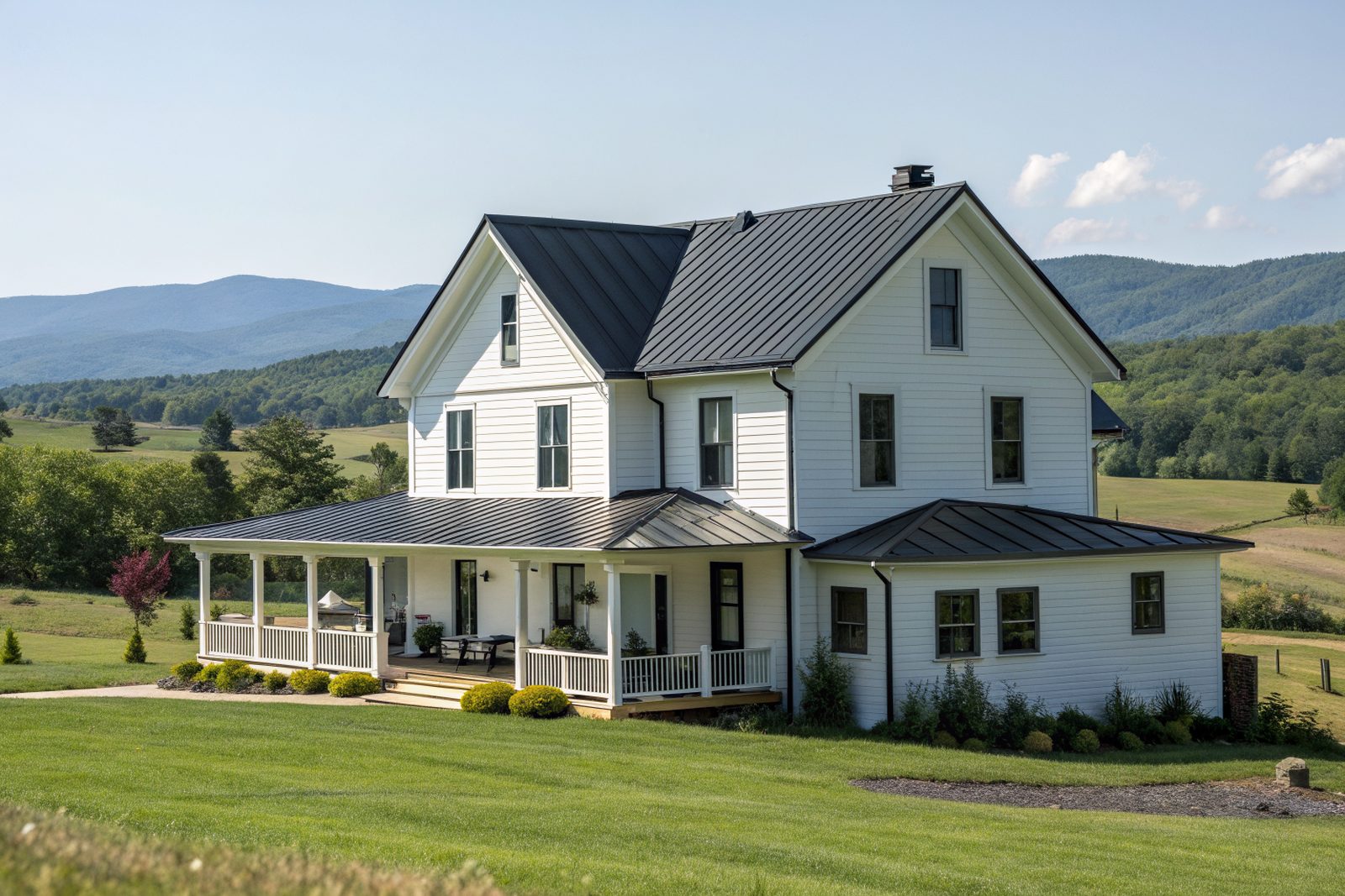 A white two-story farmhouse with a charcoal standing-seam metal roof and a wide porch